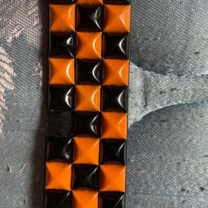 orange and black studded belt